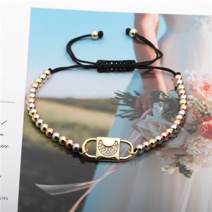 Macro shot of adjustable black cord bracelets with gold and silver moon zircon charms