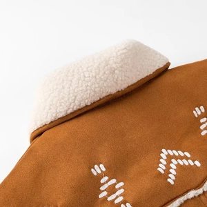 Detail of caramel suede jacket with white faux fur collar and intricate back embroidery