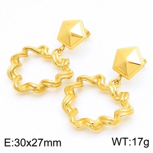 Macro detail of gold geometric pyramid stud earrings with irregular wavy hoop pendants