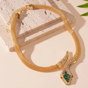 Detailed view of gold mesh chain snake necklace with green and clear rhinestones