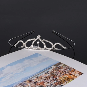 Detailed view of silver crystal bridal crown with heart patterns and sparkling rhinestones