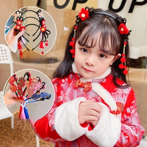 Close-up of red Chinese traditional headband with flower petals and hanging tassels