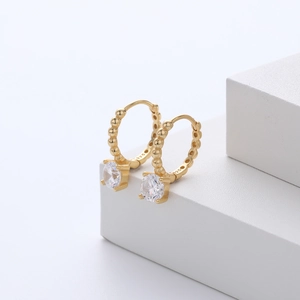Close-up of S925 sterling silver gold-plated hoop earrings with sparkling cubic zirconia