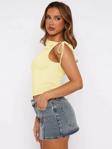 Detail view of yellow halter neck crop top with side drawstring tie and ruched design