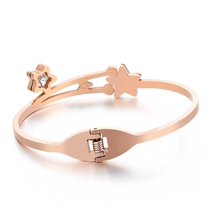 Rose gold stainless steel star bracelet with zircon inlay on a white background