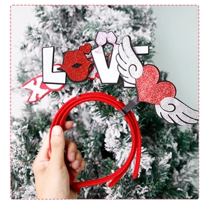 Detail of red glitter LOVE headband with spring-loaded hearts and champagne glass design