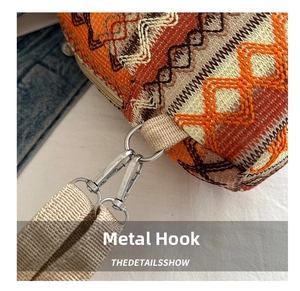 Detail of silver metal hook and colorful geometric jacquard fabric on ethnic backpack