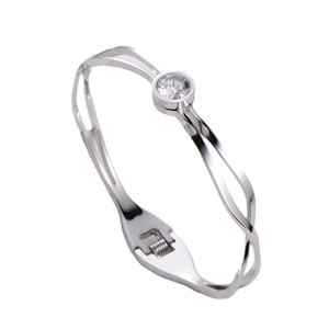 Sleek silver titanium steel bangle with a single zircon stone in a minimalist design