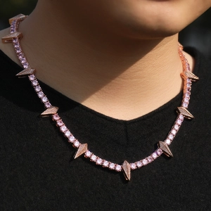 Rose gold hip hop necklace with pink zircons and geometric spikes worn by a model