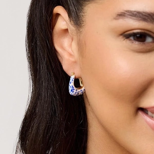 18K gold plated blue and white porcelain enamel hoop earrings on model ear