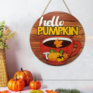 Close-up of Hello Pumpkin wooden door sign hanging on wall with autumn decorations
