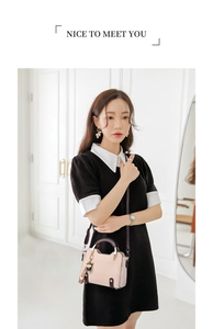 Close-up of pink bicolor mini handbag with adjustable strap and cute animal charm