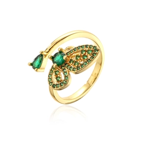Detailed macro view of 18K gold butterfly ring with micro-pave emerald green cubic zirconia