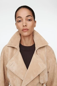 Detail of beige faux suede jacket showing notched lapel and soft fabric texture