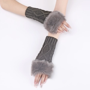 Detailed close-up of dark grey cable knit arm warmers with plush faux fur trim