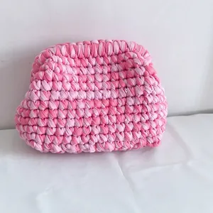 Detail of pink hand-knitted crochet cloud bag showing compact textured weave fabric