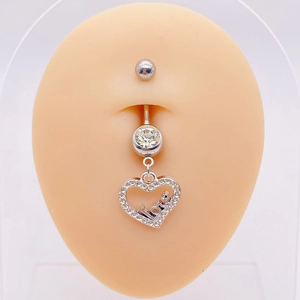Macro shot of silver heart belly ring with Love engraving and sparkling cubic zirconia