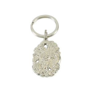 Detailed close-up of a silver zodiac dragon relief pendant on a stainless steel keychain