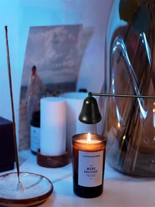 Black candle extinguisher bell tool set for scented candles, home fragrance accessory detail view.