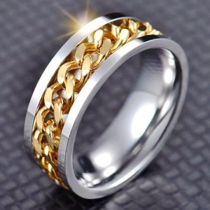 Macro view of gold chain link inlay on stainless steel spinner ring for anxiety relief