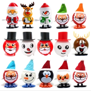 Set of 15 Christmas wind-up toys including Santa, reindeer and penguins on white background