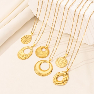 Macro shot of six gold-plated vintage necklaces with hollow geometric and sunburst pendants