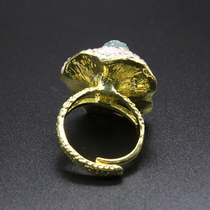 Macro shot of vintage gold flower ring with blue gemstone and colorful diamonds
