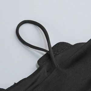 Detailed macro view of black elastic straps and soft fabric edging on the skirt set