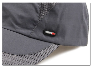 Detailed macro view of dark grey mesh fabric and sports label on breathable sun hat