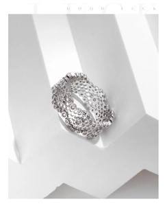 Macro detail of silver honeycomb hollow ring with pave crystals and lace edges