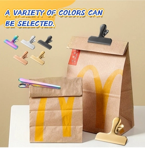 Close-up of colorful stainless steel sealing clips on a paper bag showing practical usage