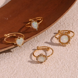 Close-up of four 18K gold plated rings with opal stones in drop, heart, sun and flower shapes