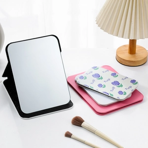 Detail shot of foldable PU leather makeup mirrors with elegant tulip floral patterns
