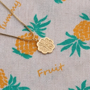 Gold plated box chain necklace with a textured flower pendant engraved with number 18