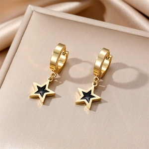 Polished gold hoop earrings with black star charms on a luxury jewelry box setting