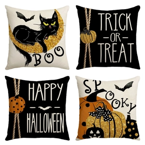 Detail view of four linen Halloween pillow covers with glitter patterns and festive text