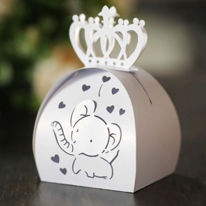 Detailed view of white hollow heart elephant candy box with elegant crown top closure