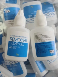 Macro detail of 15ml clear gel eyelash extension remover bottles in bulk display