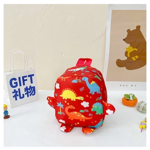 Detail of red cartoon dinosaur backpack for kids with vibrant prints and decorative wings