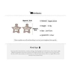 Detail view of silver-tone star saturn stud earrings with cubic zirconia and silver pins
