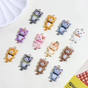 Flat lay view of twelve colorful cartoon resin cat pendants for DIY jewelry making