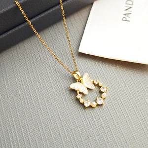Elegant gold butterfly necklace with mother of pearl, pearls and zircon crystals