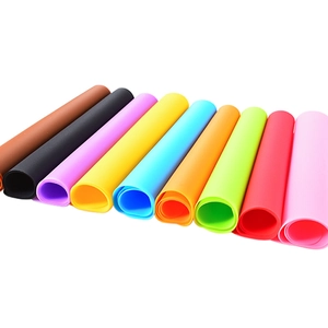 Rolls of colorful 30x40cm silicone table mats for kids and pets in 9 bright colors