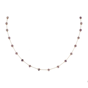 Detail of gold chain necklace featuring purple cylinder natural stone beads spaced evenly