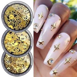 Golden nail art charms set with stars and moons in storage case with application on nails