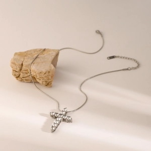 Silver stainless steel cross necklace with sparkling white zircon pendant on stone