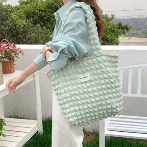Detail of light green bubble texture fabric on tote bag with LOVE SOZAKKA label