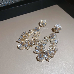 Macro shot of sparkling tassel earrings with pear and marquise-cut crystal diamonds