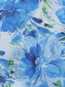 Close-up of bohemian floral pattern on breathable fabric with elegant blue watercolor leaves