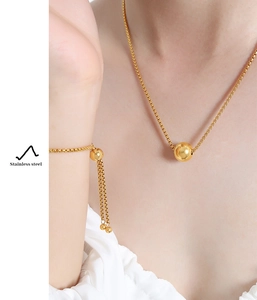 Detail of gold-plated stainless steel bead pendant necklace and box chain bracelet set